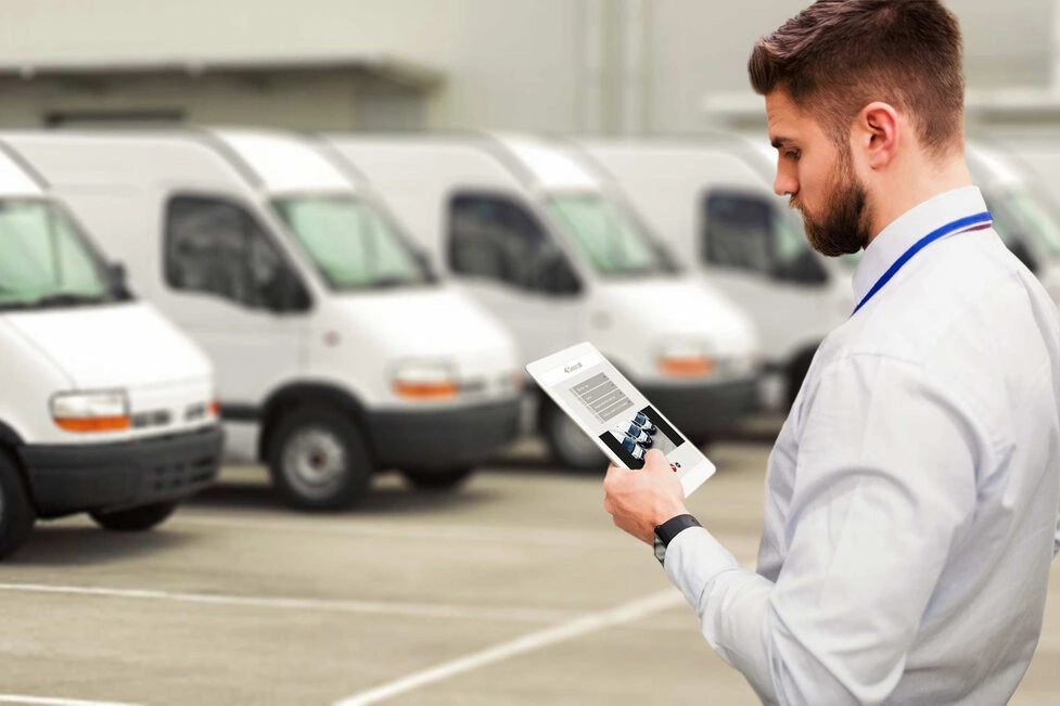 Fleet of white work vans ready for scheduled maintenance